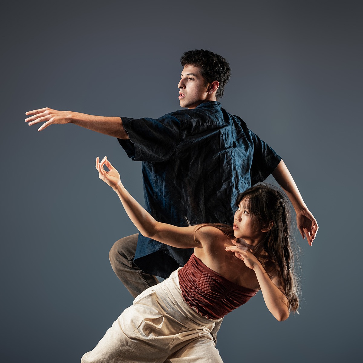 Two dancers against grey background 