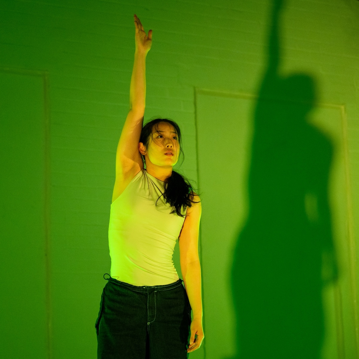 Dancer in green lit room 