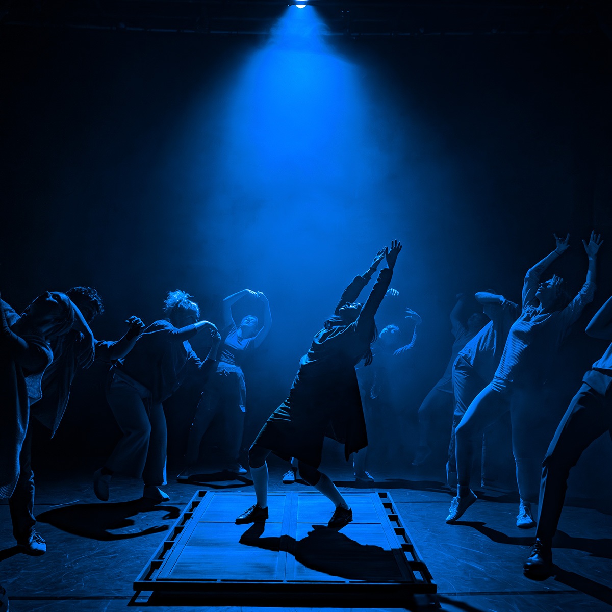 Group of dancers under blue lighting 